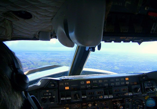 View from inside the cockpit of farmland below